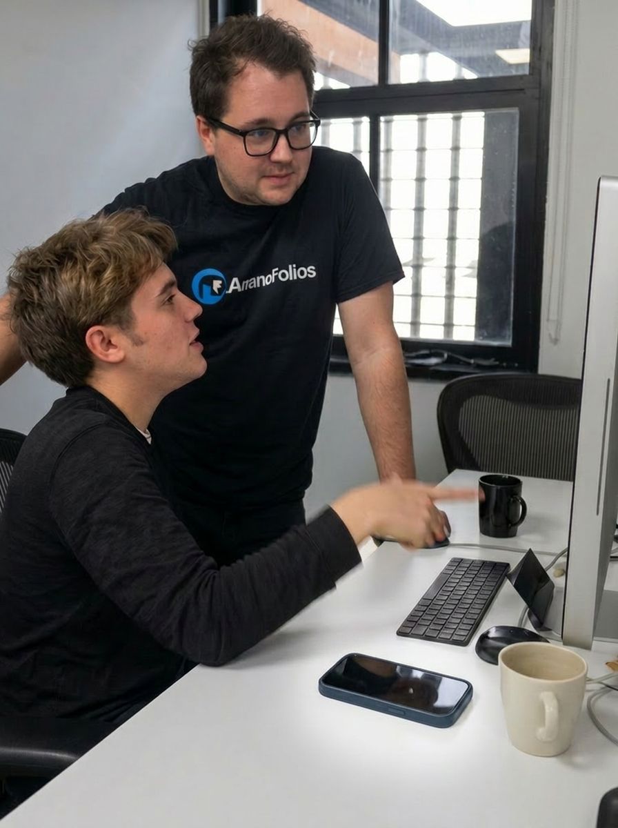 A founder reviewing work at an engineer’s desk